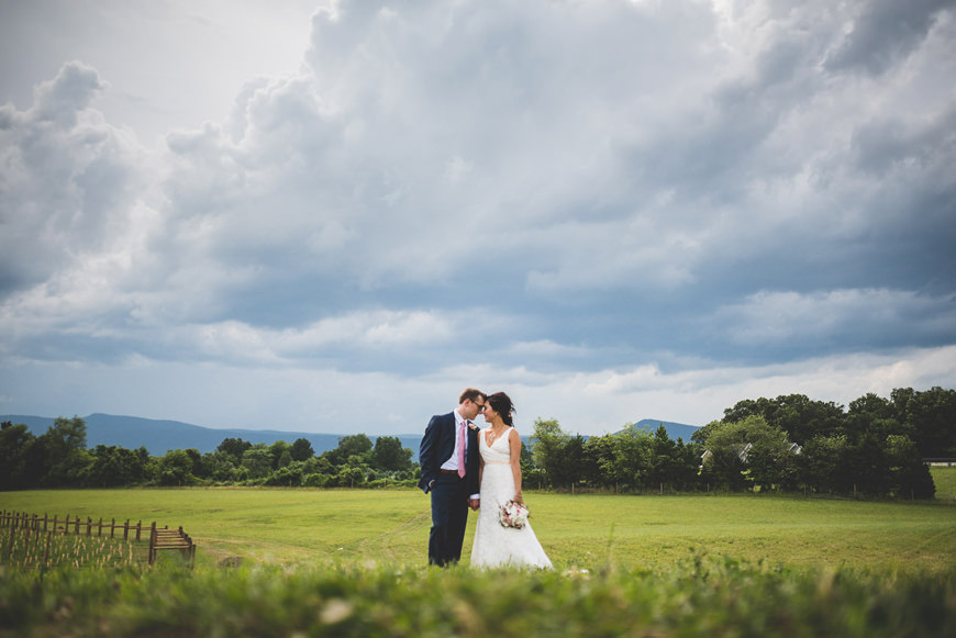 005 bride and groom under epic clouds