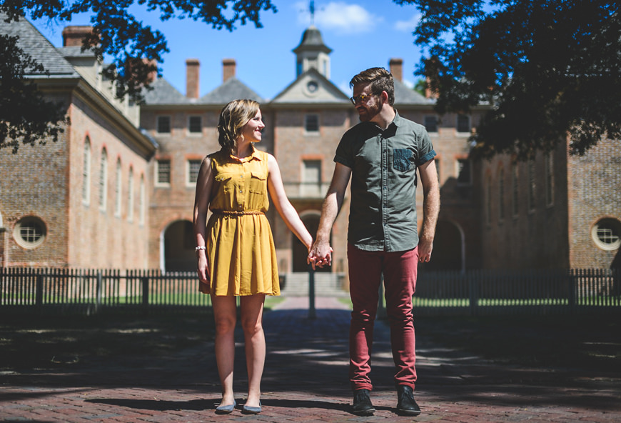 005 couple holding hands in front of building