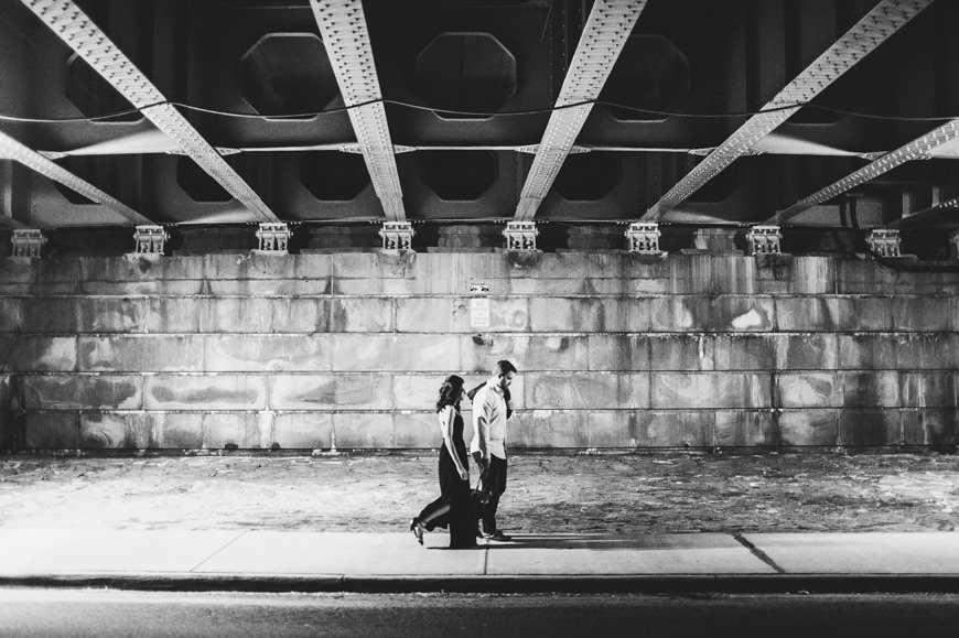 013 black and white couple walking under bridge
