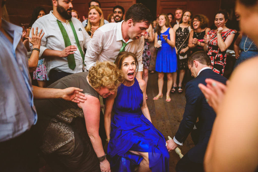 mother of the groom in a chair at a jewish wedding lifted off the ground