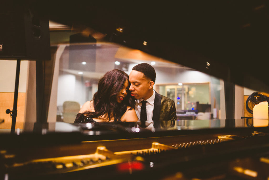 black couple engagement at a piano in a recording studio in richmond virginia